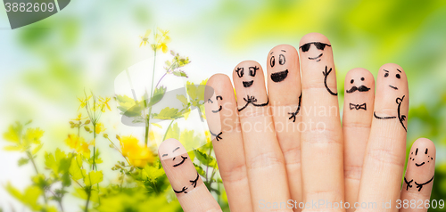 Image of close up of hands and fingers with smiley faces