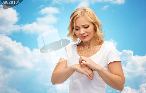 Image of unhappy woman suffering from hand inch