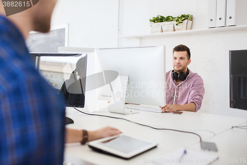 Image of creative man with headphones and computer
