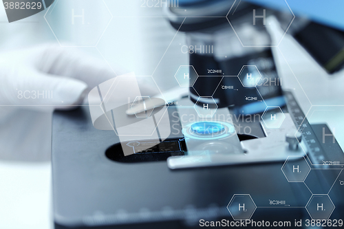 Image of close up of scientist hand with test sample in lab