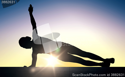 Image of woman doing plank exercise on stairs over sunlight