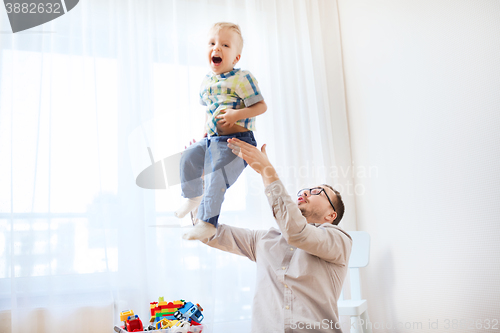 Image of father with son playing and having fun at home