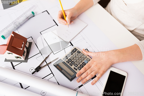 Image of close up of architect hand counting on calculator