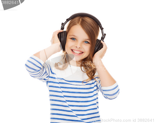 Image of smiling girl with headphones listening to music