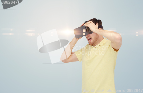 Image of happy man in virtual reality headset or 3d glasses