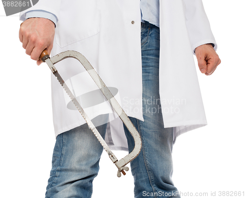 Image of Crazy doctor is holding a big saw in his hands