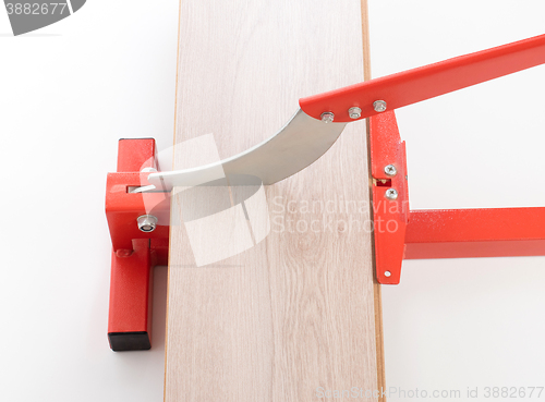 Image of Red tool for cutting laminate