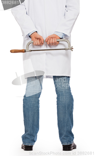 Image of Crazy doctor is holding a big saw in his hands