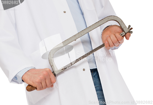 Image of Crazy doctor is holding a big saw in his hands