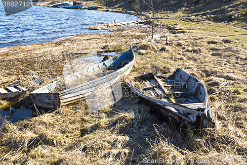 Image of Old fishing boats on lake coast