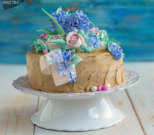 Image of Festive coffee cake with flowers of cream.