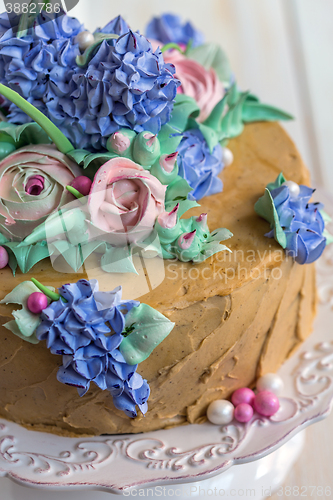 Image of Festive cake with flowers of cream closeup.