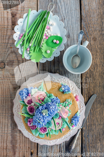 Image of Dish with cake and decorative elements from sugar mastic.