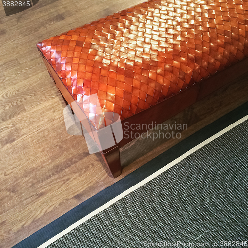 Image of Fancy leather bench on wooden floor