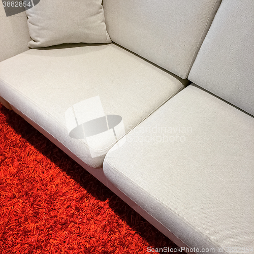 Image of White sofa on red carpet