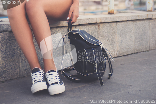 Image of closeup of woman legs in white gumshoes