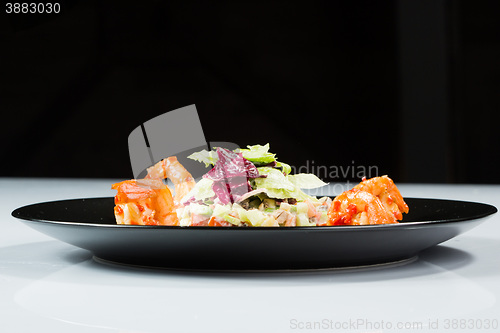 Image of perfect dish with shrimps on a black plate. seafood