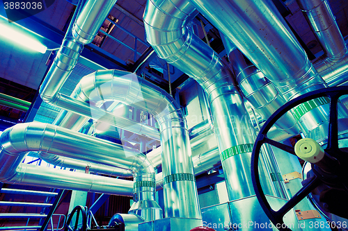 Image of different size and shaped pipes and valves at a power plant 