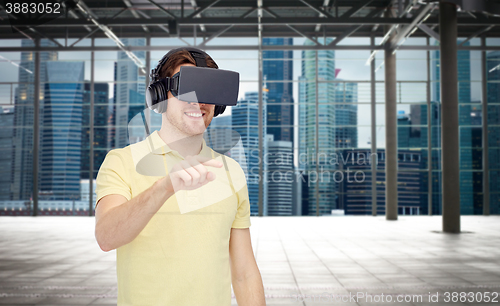 Image of happy man in virtual reality headset or 3d glasses