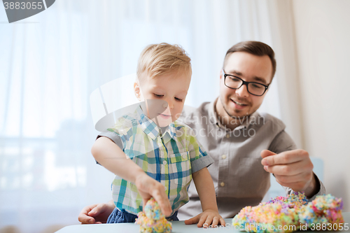 Image of father and son playing with ball clay at home