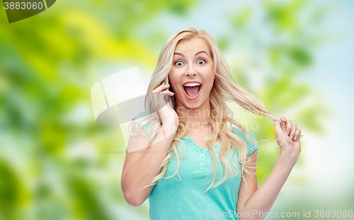 Image of smiling young woman calling on smartphone