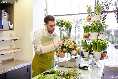 Image of florist man making bunch at flower shop