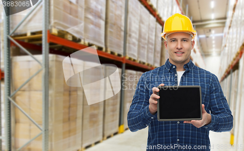 Image of happy businessman with tablet pc at warehouse