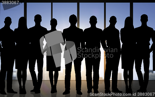 Image of business people silhouettes over office background