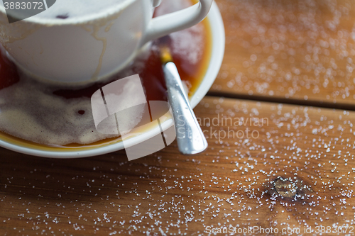 Image of close up coffee cup and sugar on wooden table