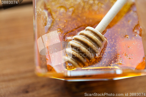 Image of close up of honey in glass bowl and dipper