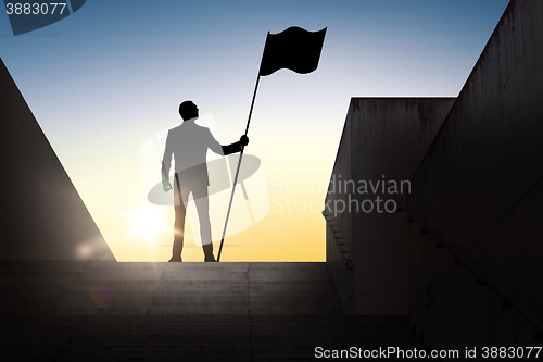 Image of silhouette of businessman with flag over sun light