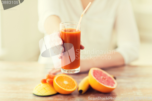 Image of close up of woman hands with juice and fruits