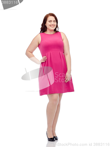 Image of happy young plus size woman posing in pink dress