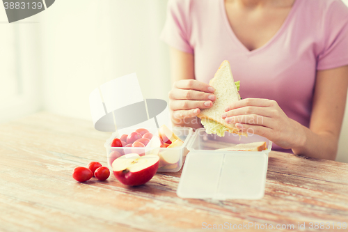 Image of close up of woman with food in plastic container