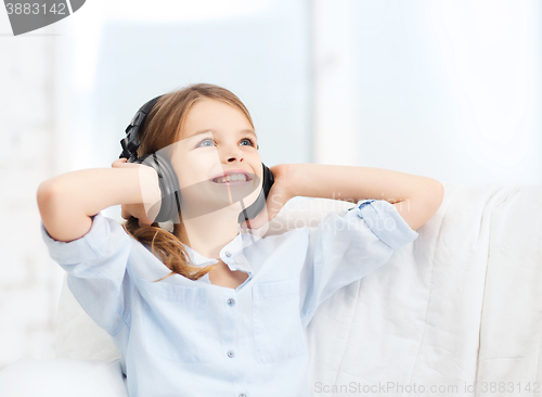 Image of smiling girl with headphones listening to music