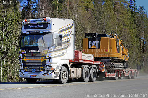 Image of Scania Semi Hauls CAT Hydraulic Excavator