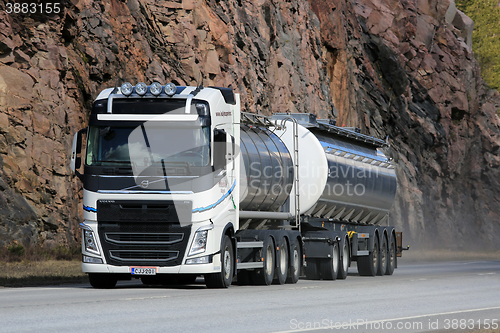 Image of White Volvo FH Tank Truck on Highway with Rock Background