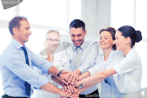 Image of business team celebrating victory in office