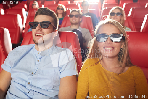 Image of happy friends watching movie in 3d theater