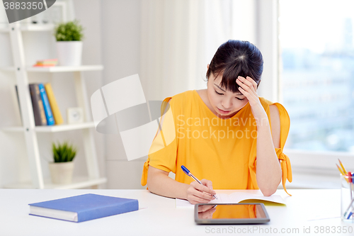 Image of tired asian woman student with tablet pc at home