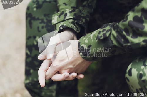 Image of close up of young soldier in military uniform