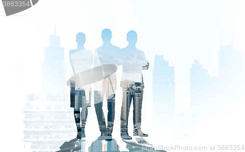 Image of business people silhouettes over city background