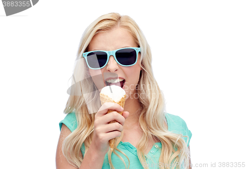 Image of happy young woman in sunglasses eating ice cream