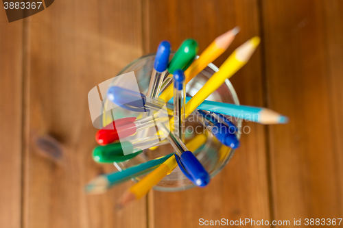 Image of close up of stand or glass with pens and pencils