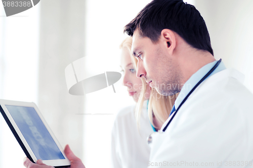 Image of two doctors looking at x-ray on tablet pc