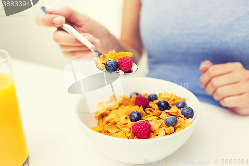 Image of close up of woman eating corn flakes for breakfast
