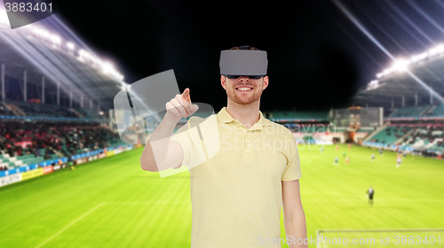 Image of man in virtual reality headset over football field