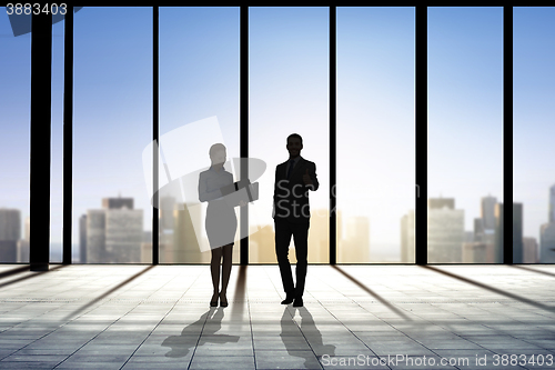 Image of silhouettes of business partners with folders