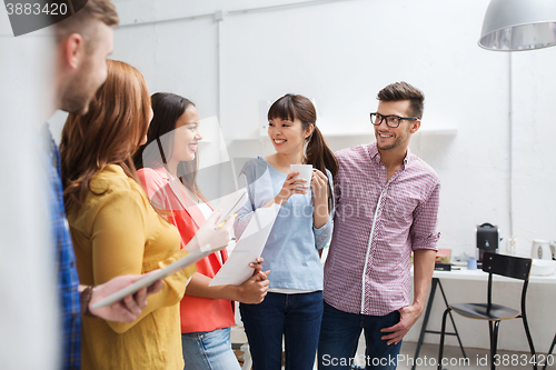 Image of creative team on coffee break talking at office