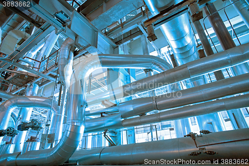 Image of different size and shaped pipes and valves at a power plant 